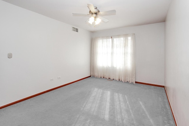 carpeted spare room with ceiling fan