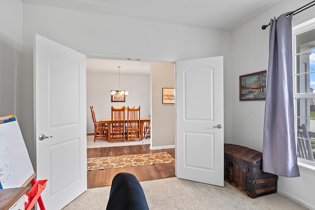 home office featuring a notable chandelier and hardwood / wood-style flooring