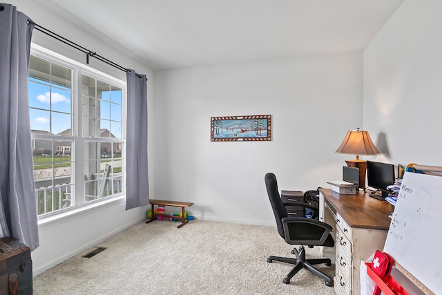 office with carpet flooring and a healthy amount of sunlight