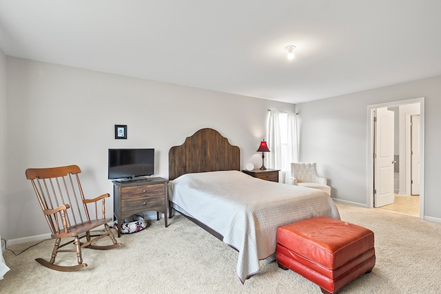 bedroom with carpet and connected bathroom