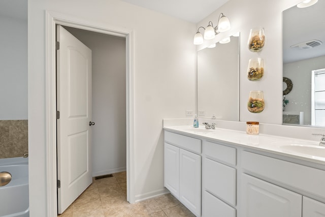 bathroom with tile patterned floors, vanity, and a bath