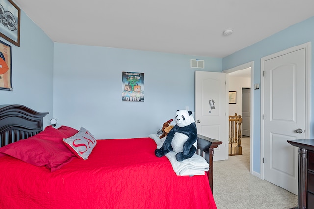 bedroom featuring light carpet