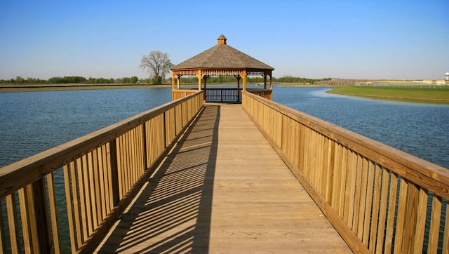 view of dock featuring a gazebo and a water view