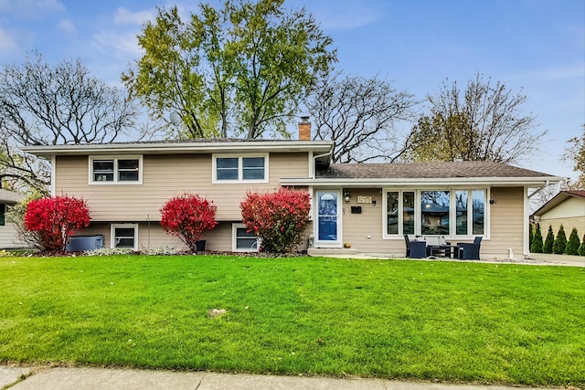 split level home with a front yard