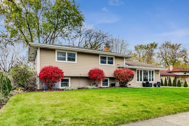 tri-level home with a front lawn