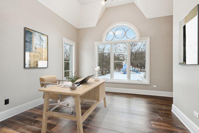 office with plenty of natural light, dark hardwood / wood-style floors, and lofted ceiling