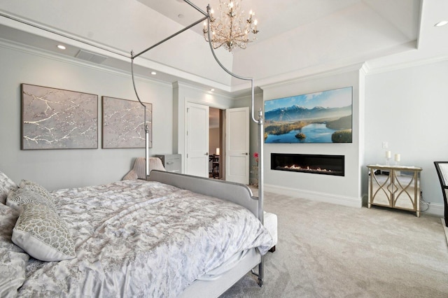 bedroom with a raised ceiling, carpet, ornamental molding, and a notable chandelier