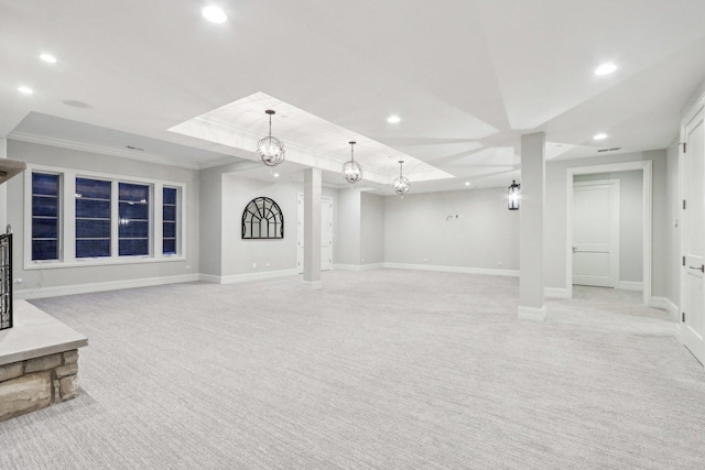 unfurnished living room with light colored carpet, a tray ceiling, and ornamental molding