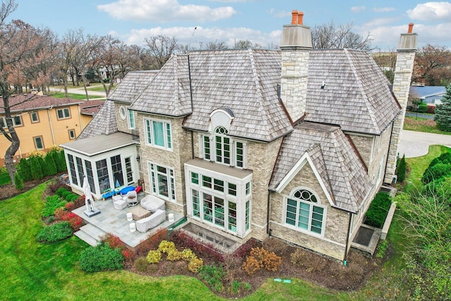 back of house featuring a patio and a sunroom