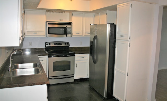 kitchen with white cabinetry, sink, and stainless steel appliances