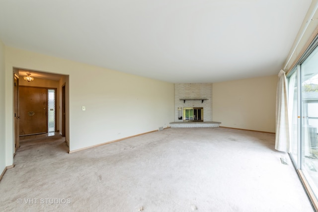 unfurnished living room with a fireplace and light colored carpet