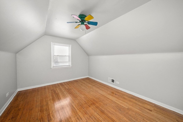 bonus room with lofted ceiling, ceiling fan, visible vents, baseboards, and wood-type flooring