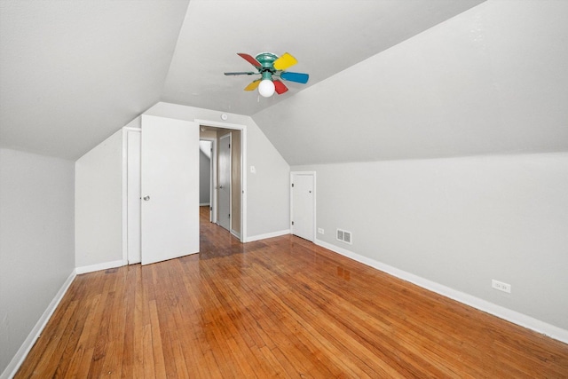 bonus room featuring visible vents, baseboards, a ceiling fan, lofted ceiling, and wood-type flooring