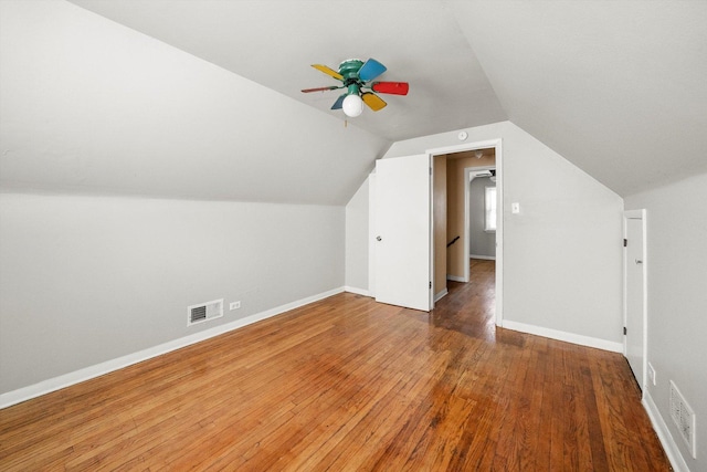 bonus room featuring ceiling fan, visible vents, baseboards, vaulted ceiling, and hardwood / wood-style floors