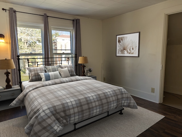 bedroom featuring dark hardwood / wood-style flooring and ornamental molding