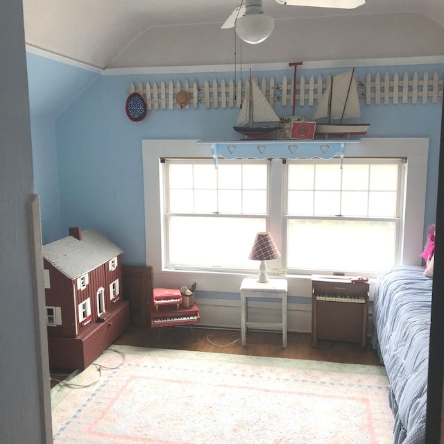 bedroom with hardwood / wood-style floors, ceiling fan, and lofted ceiling