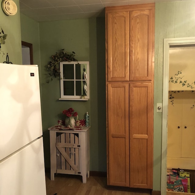 kitchen with hardwood / wood-style flooring and white refrigerator