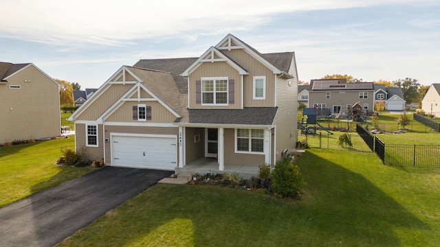 craftsman inspired home featuring a garage and a front lawn