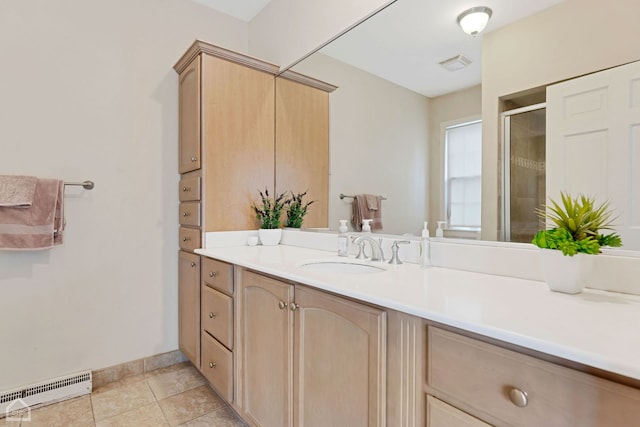 bathroom featuring vanity, tile patterned floors, and a shower with door