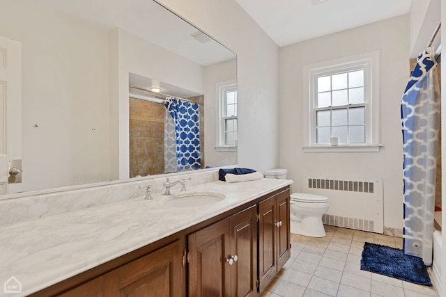 bathroom with tile patterned floors, vanity, toilet, and radiator