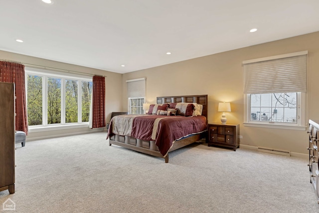 bedroom featuring light carpet, a baseboard radiator, and multiple windows