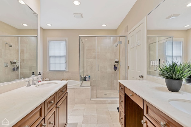 bathroom featuring tile patterned floors, plus walk in shower, and vanity