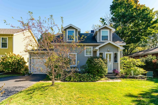 view of front of house featuring a front lawn and a garage