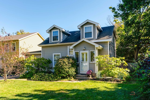 new england style home featuring a front yard