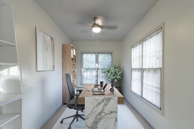 office area featuring ceiling fan, plenty of natural light, and light colored carpet