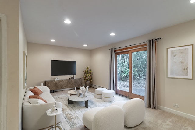 carpeted living room featuring a baseboard radiator