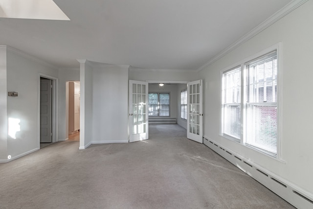 carpeted empty room featuring crown molding, a baseboard radiator, and french doors