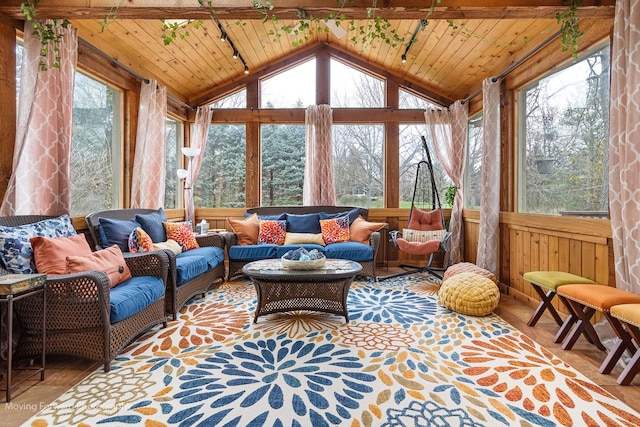 sunroom featuring lofted ceiling, wood walls, wooden ceiling, and an outdoor hangout area