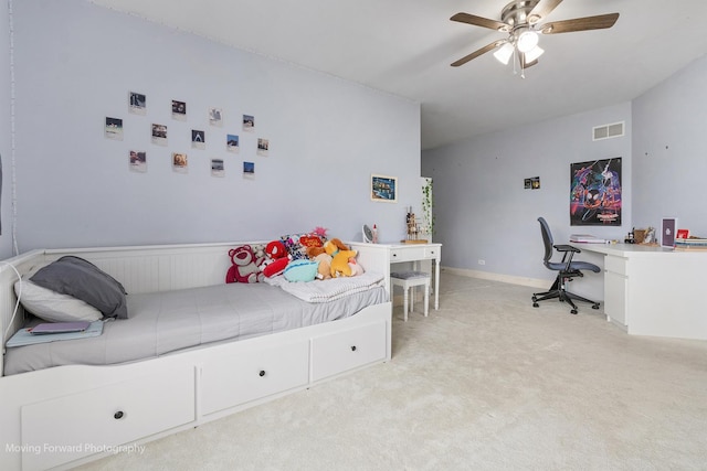 bedroom with light colored carpet, a ceiling fan, and visible vents