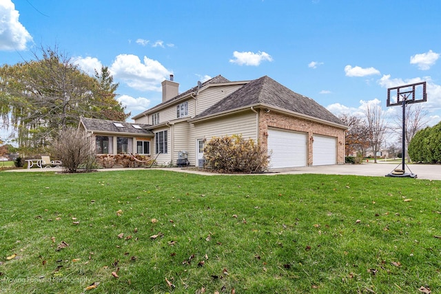 view of home's exterior featuring a chimney, driveway, a yard, a garage, and brick siding