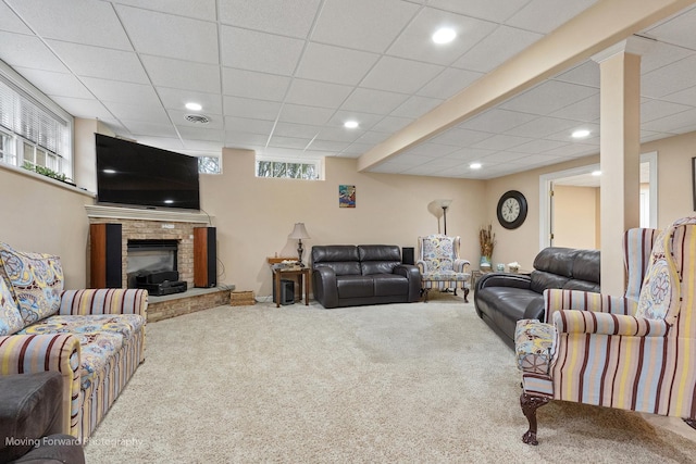 living room featuring carpet floors, a brick fireplace, visible vents, and recessed lighting
