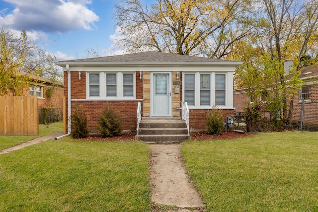 bungalow-style home featuring a front yard