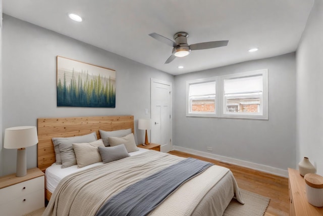 bedroom with light wood-type flooring and ceiling fan