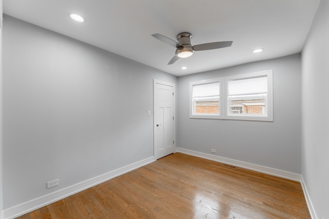 empty room with ceiling fan and light hardwood / wood-style floors