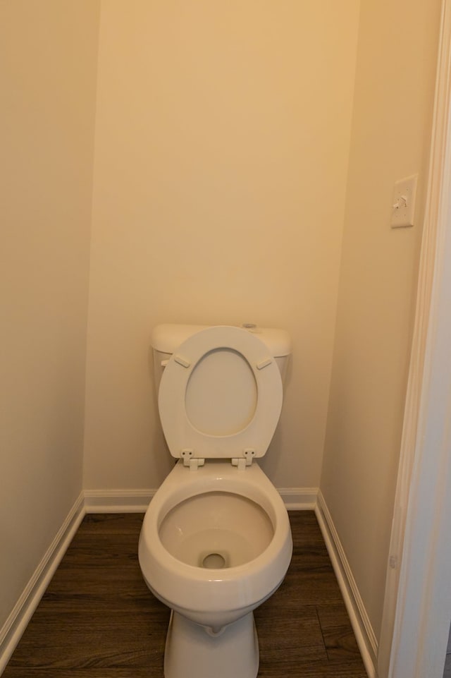 bathroom with hardwood / wood-style floors and toilet