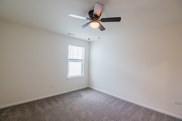 carpeted spare room with ceiling fan