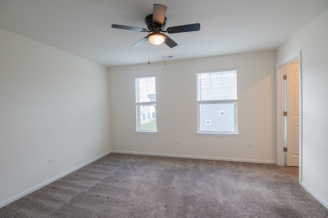 carpeted spare room with ceiling fan