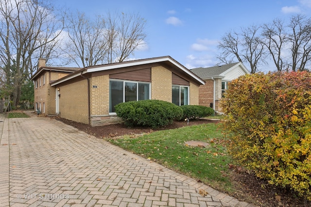 view of side of home with a yard