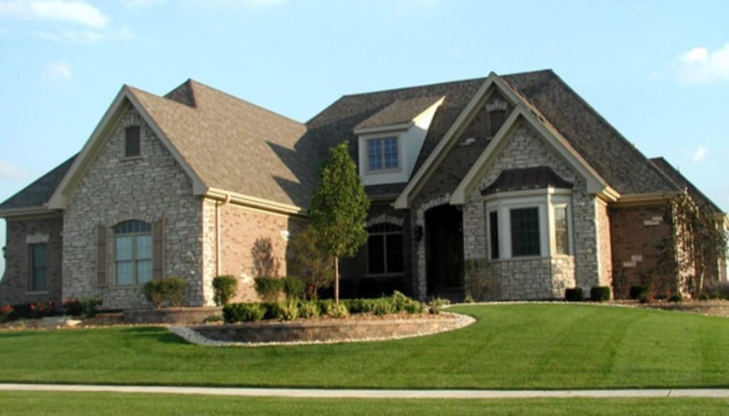 french country style house featuring a front lawn