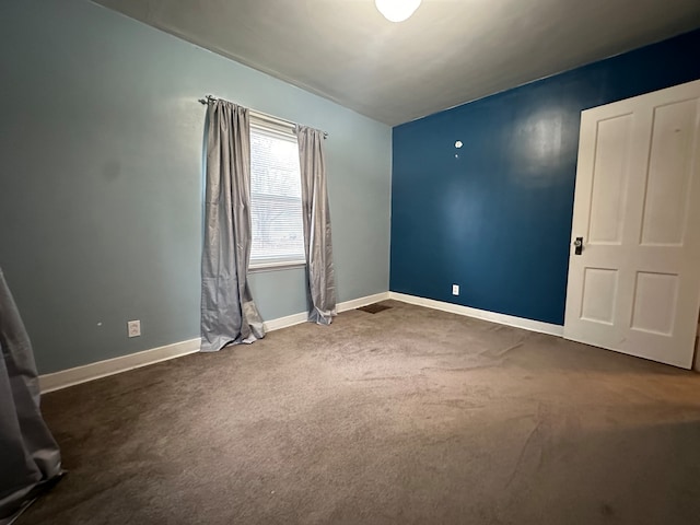 empty room with dark carpet