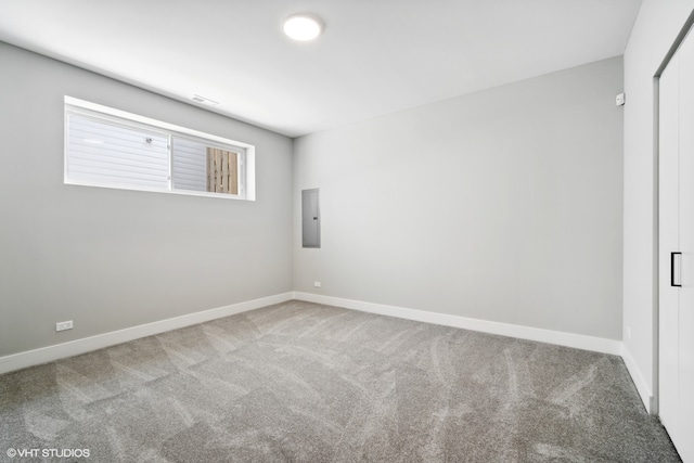 unfurnished room featuring electric panel and carpet floors