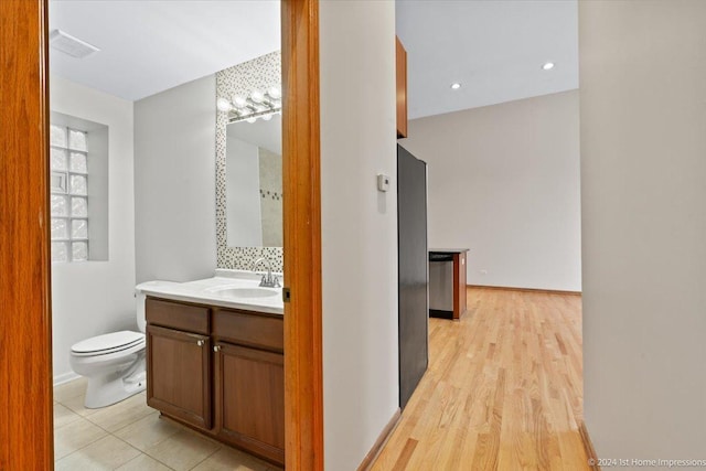 bathroom with vanity, toilet, and wood-type flooring