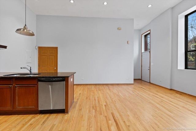 kitchen featuring dishwasher, pendant lighting, light hardwood / wood-style flooring, and sink