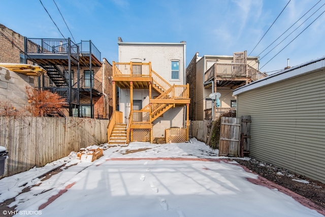 view of snow covered rear of property