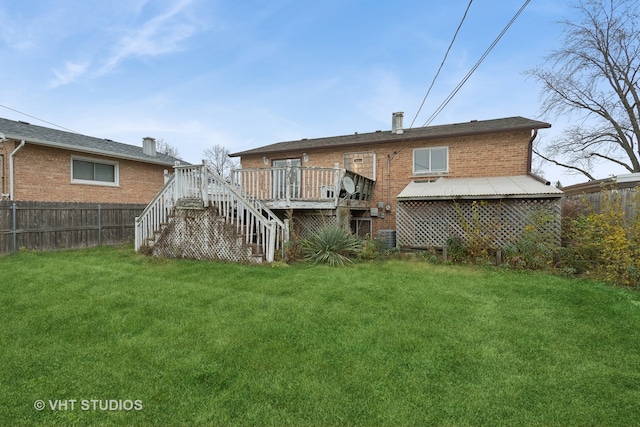 back of property featuring a lawn and a deck