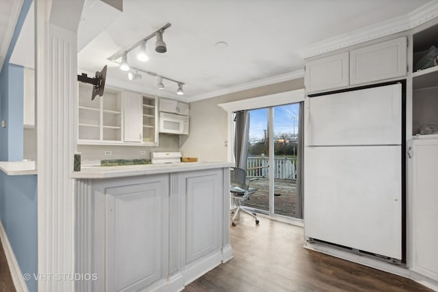 kitchen featuring white appliances, dark hardwood / wood-style floors, and white cabinetry